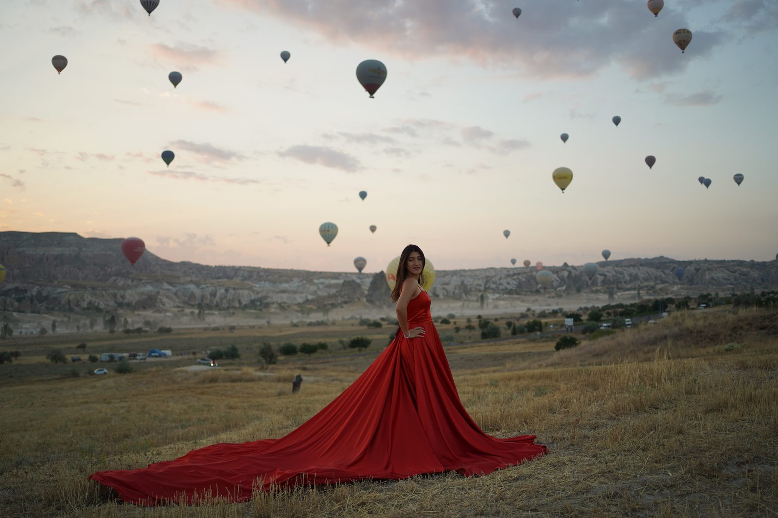 Our guest in a red dress in the Cappadocia valley at dawn